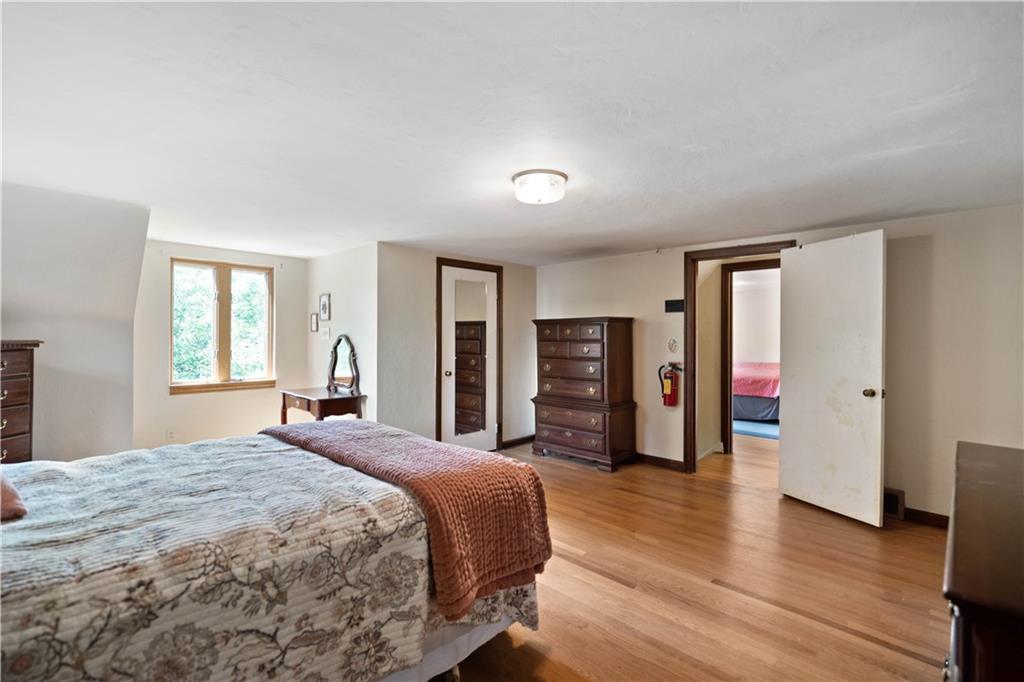 720 Perry Highway Pittsburgh, PA 15229 - Photo 29 of 39 a bedroom with a bed and wooden floor