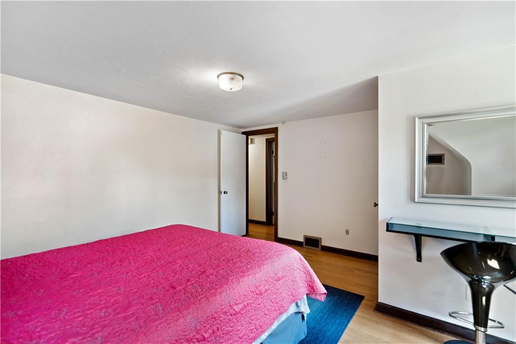 720 Perry Highway Pittsburgh, PA 15229 - Photo 33 of 39 a bedroom with a bed and a potted plant