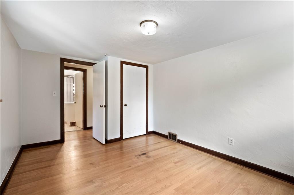 720 Perry Highway Pittsburgh, PA 15229 - Photo 35 of 39 an empty room with wooden floor and mirror