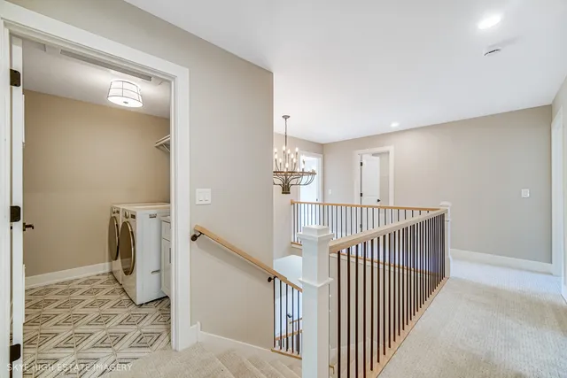 a view of a hallway with closet and stairs