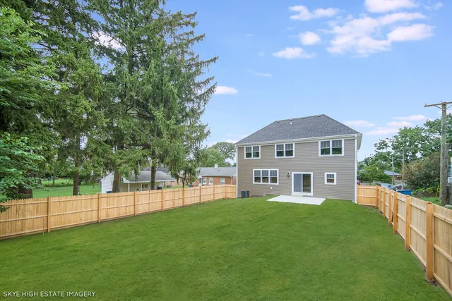 a view of yard with swimming pool and green space