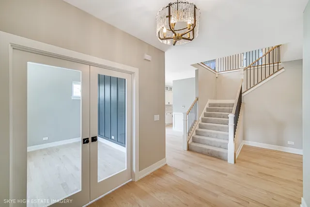 a view of a hallway with wooden floor and staircase