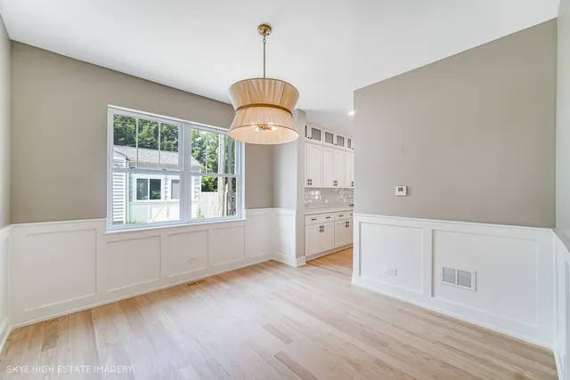 a view of a kitchen and wooden floor