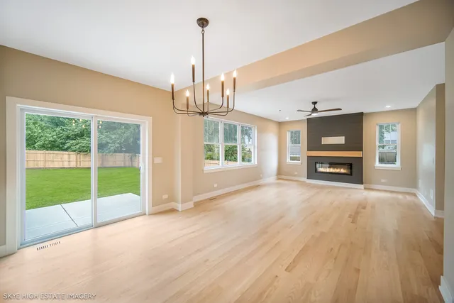 a view of empty room with wooden floor and windows