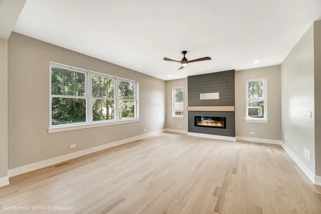 a view of an empty room with a fireplace and a window