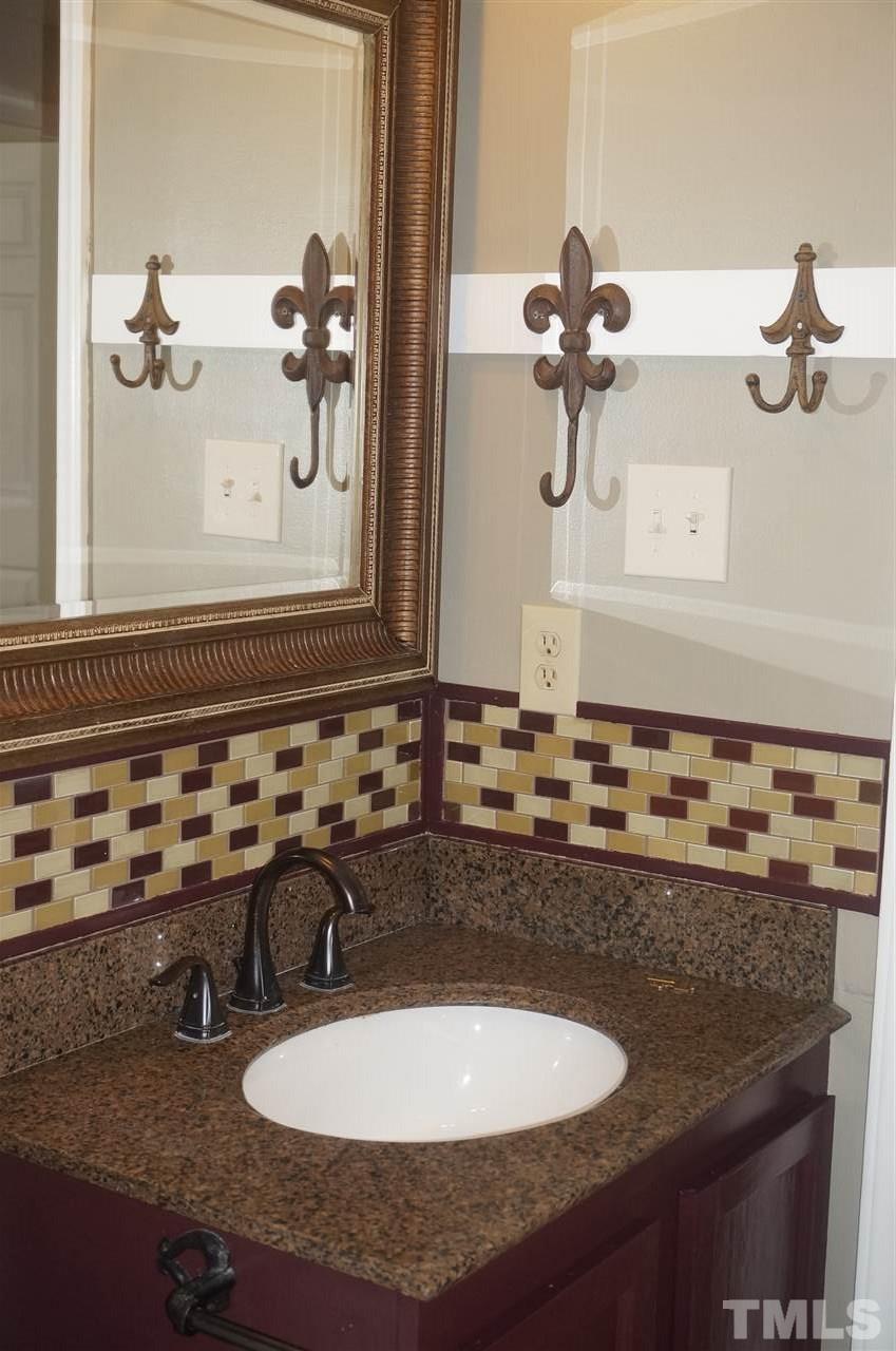 7709 Crown Crest Court Raleigh, NC 27615 - Photo 14 of 21 a bathroom with a sink and mirror