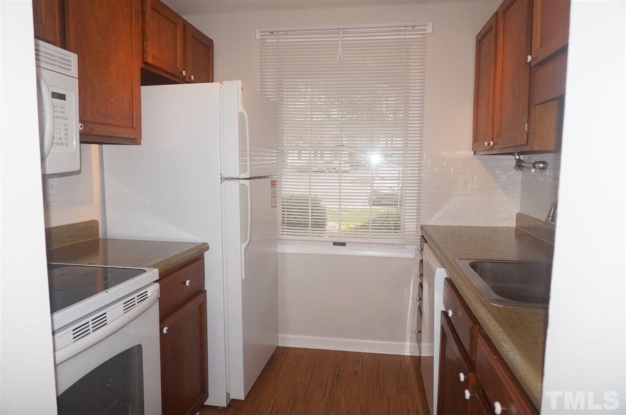 7709 Crown Crest Court Raleigh, NC 27615 - Photo 6 of 21 a kitchen with a refrigerator and a sink