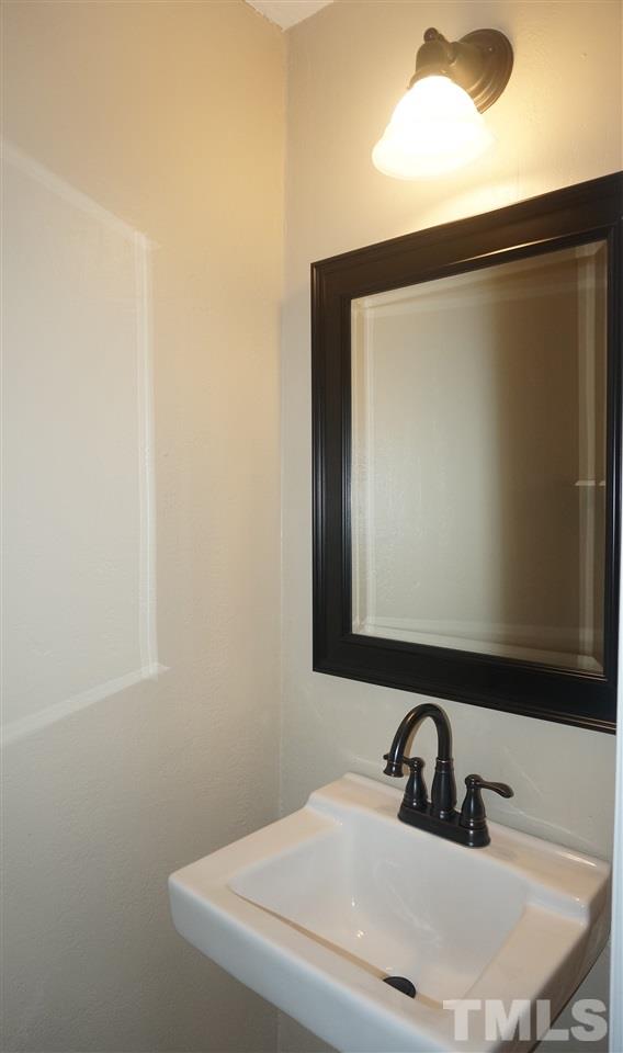 7709 Crown Crest Court Raleigh, NC 27615 - Photo 8 of 21 a bathroom with a sink and a mirror