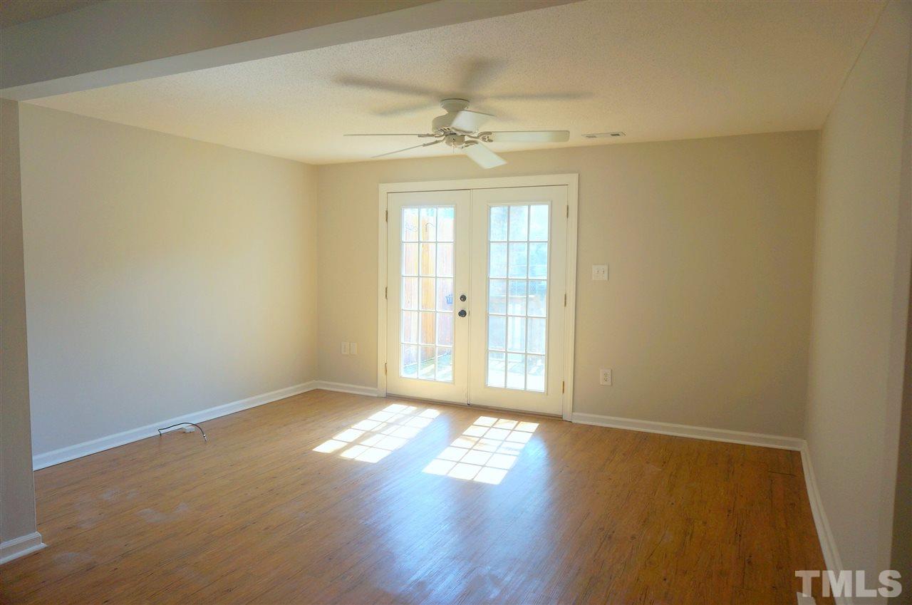 7709 Crown Crest Court Raleigh, NC 27615 - Photo 9 of 21 a view of empty room with wooden floor and fan