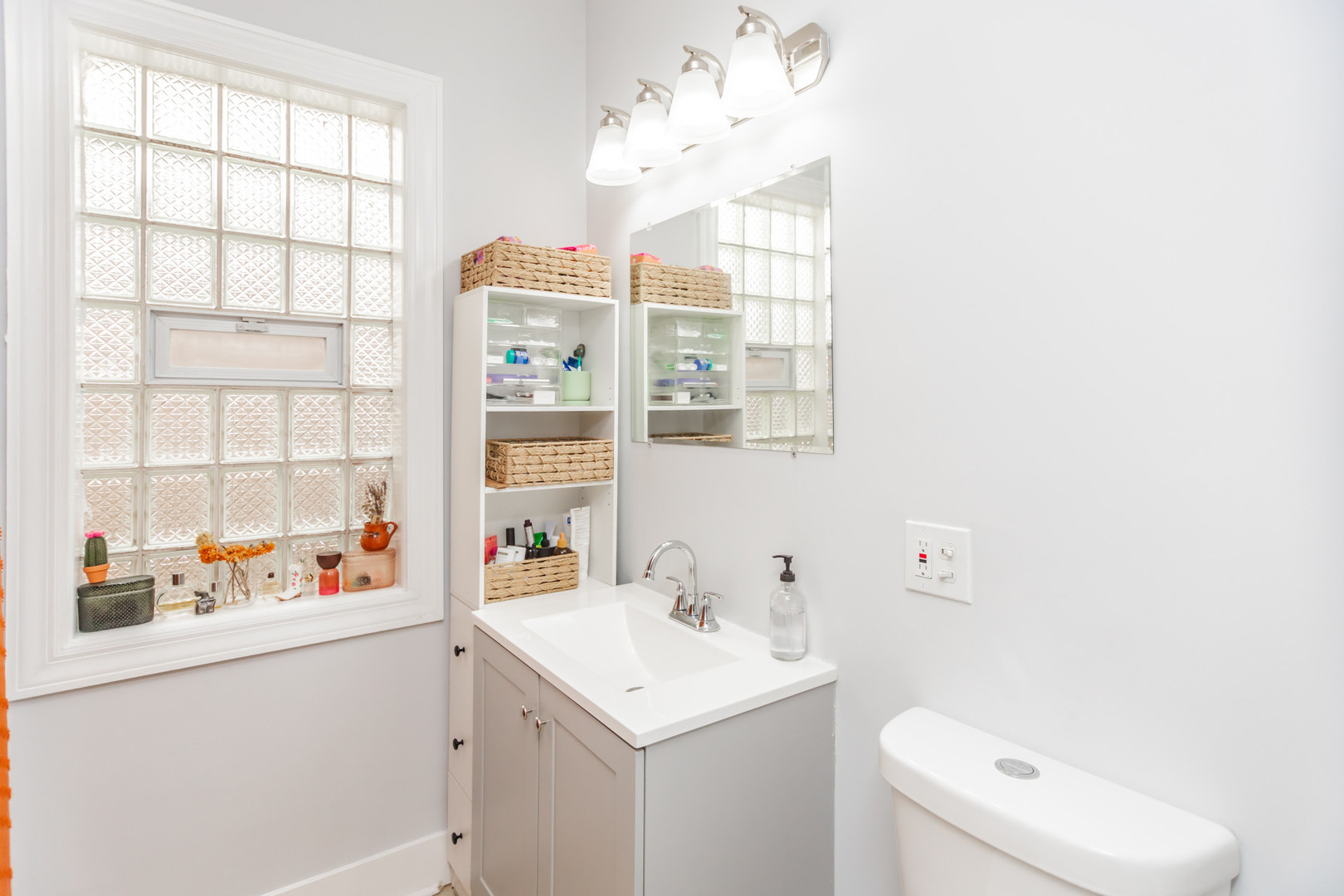 6339 South Troy Street Chicago, IL 60629 - Photo 9 of 19 a bathroom with a sink a toilet and a window
