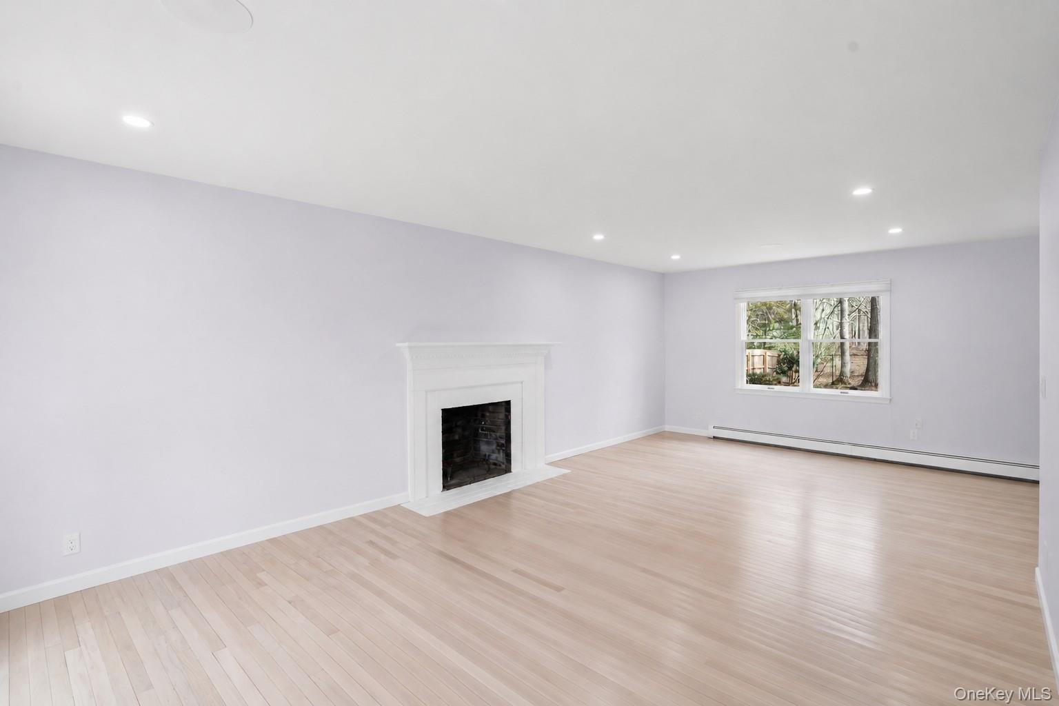 5845 North Bayview Road Southold, NY 11971 - Photo 2 of 26 Expansive living area with wood burning fire place, plenty of natural light and hardwood flooring