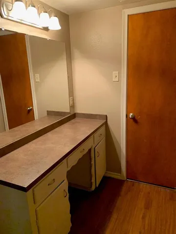 a kitchen with a sink and a mirror
