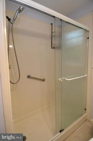 a bathroom with a glass shower door