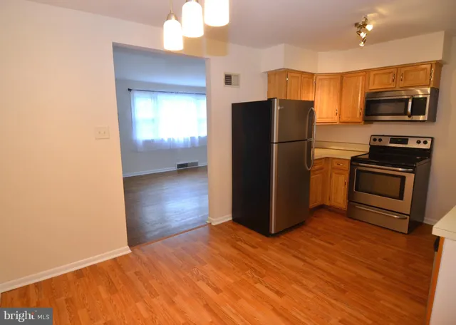 a kitchen with stainless steel appliances a refrigerator and a stove top oven