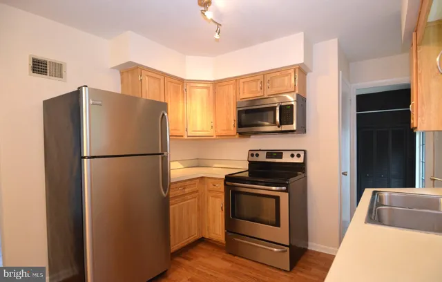 a kitchen with a refrigerator stove and microwave