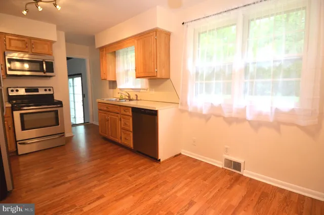 a kitchen with stainless steel appliances granite countertop a stove and a refrigerator