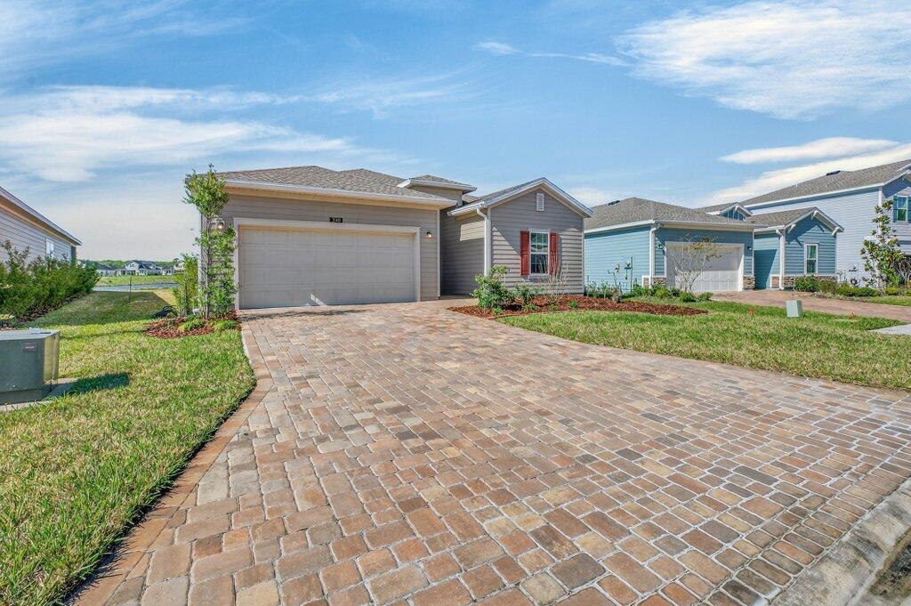 210 White Rabbit Run St. Augustine, FL 32092 - Photo 28 of 85 a front view of a house with a yard and garage