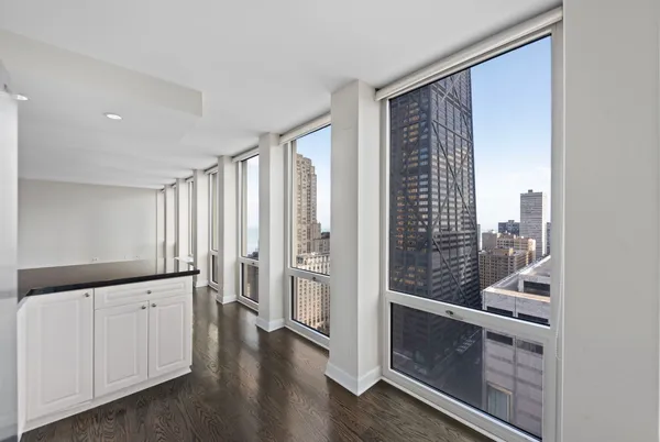 a view of wooden floor and windows in a room