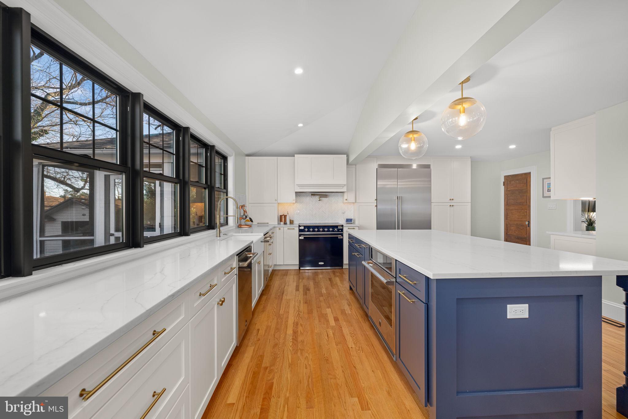 1138 Mayo Road Edgewater, MD 21037 - Photo 11 of 51 a large kitchen with stainless steel appliances kitchen island a large counter top and a wooden floors