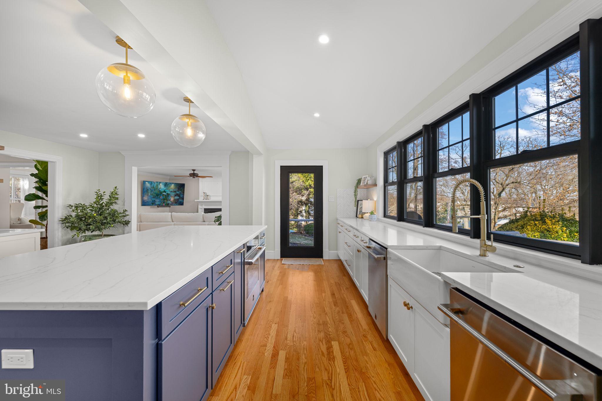 1138 Mayo Road Edgewater, MD 21037 - Photo 13 of 51 a large kitchen with kitchen island a large window a sink and cabinets