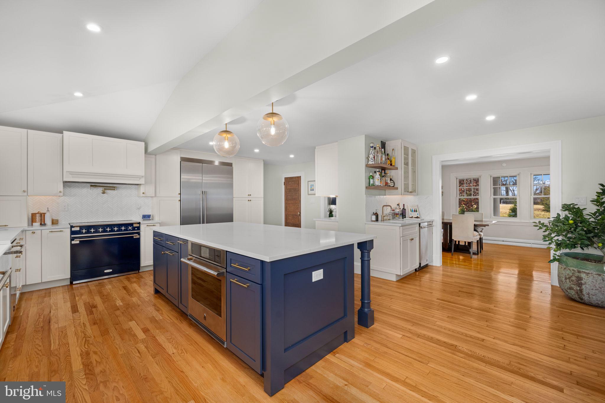 1138 Mayo Road Edgewater, MD 21037 - Photo 14 of 51 a large kitchen with stainless steel appliances granite countertop a large center island and a wooden floors