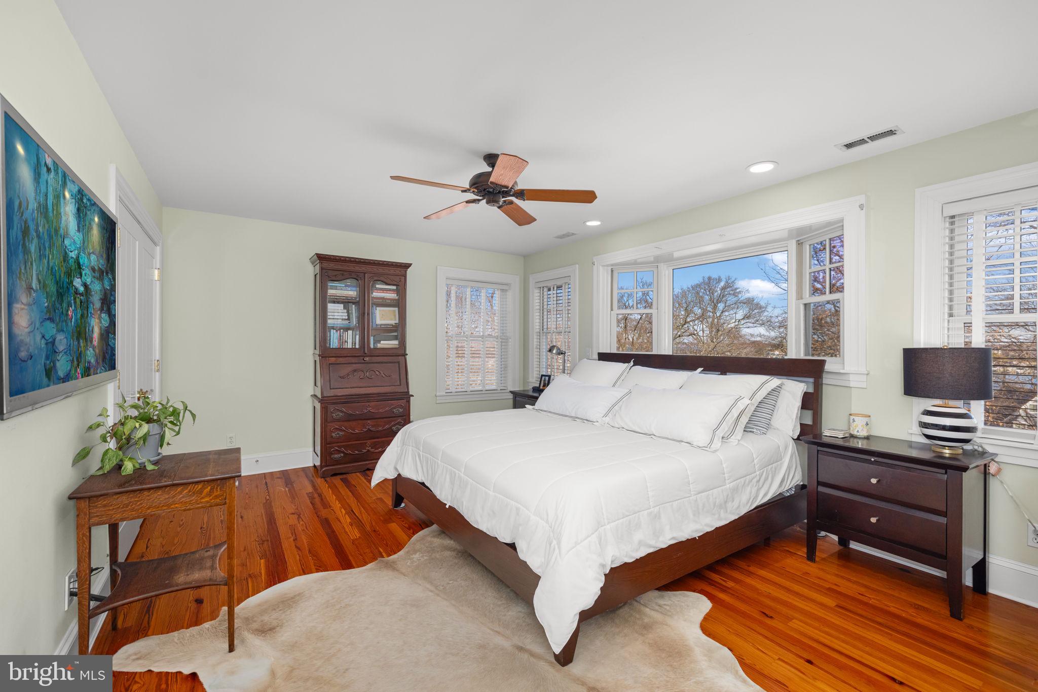 1138 Mayo Road Edgewater, MD 21037 - Photo 21 of 51 a spacious bedroom with a large bed and a chandelier