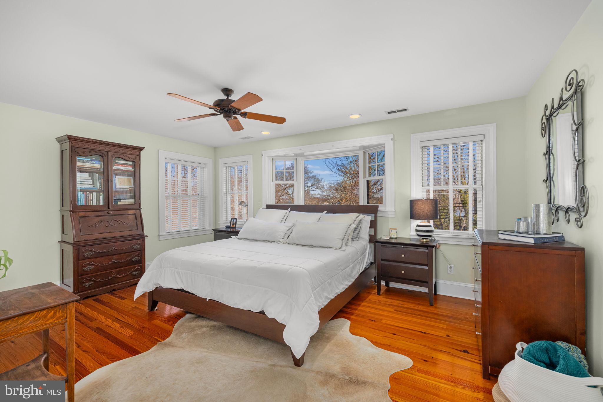 1138 Mayo Road Edgewater, MD 21037 - Photo 22 of 51 a spacious bedroom with a large bed and a chandelier