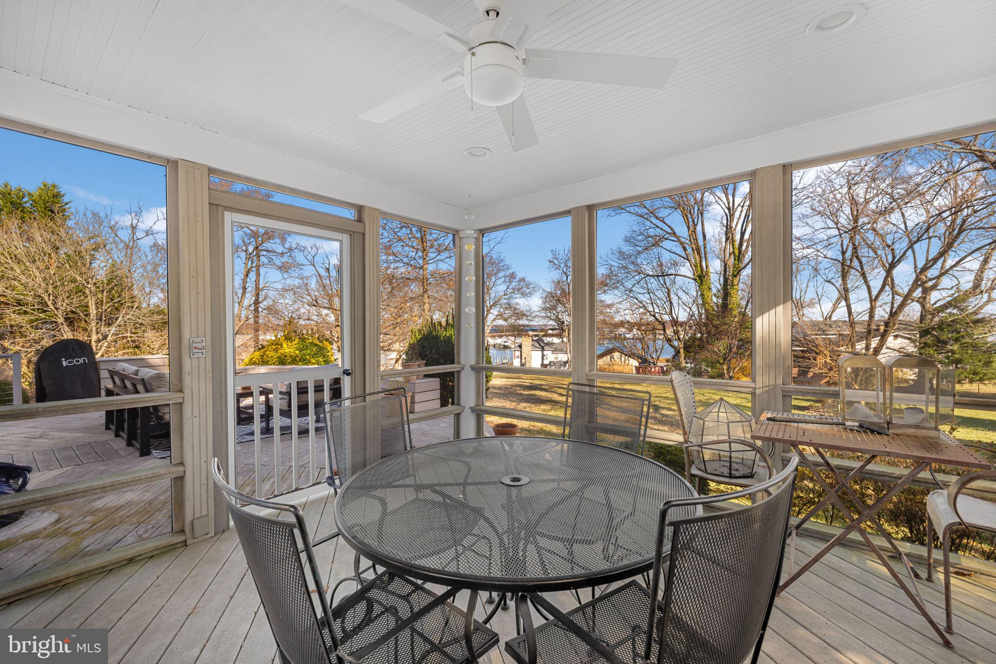 1138 Mayo Road Edgewater, MD 21037 - Photo 38 of 51 a dining room with furniture a chandelier and wooden floor