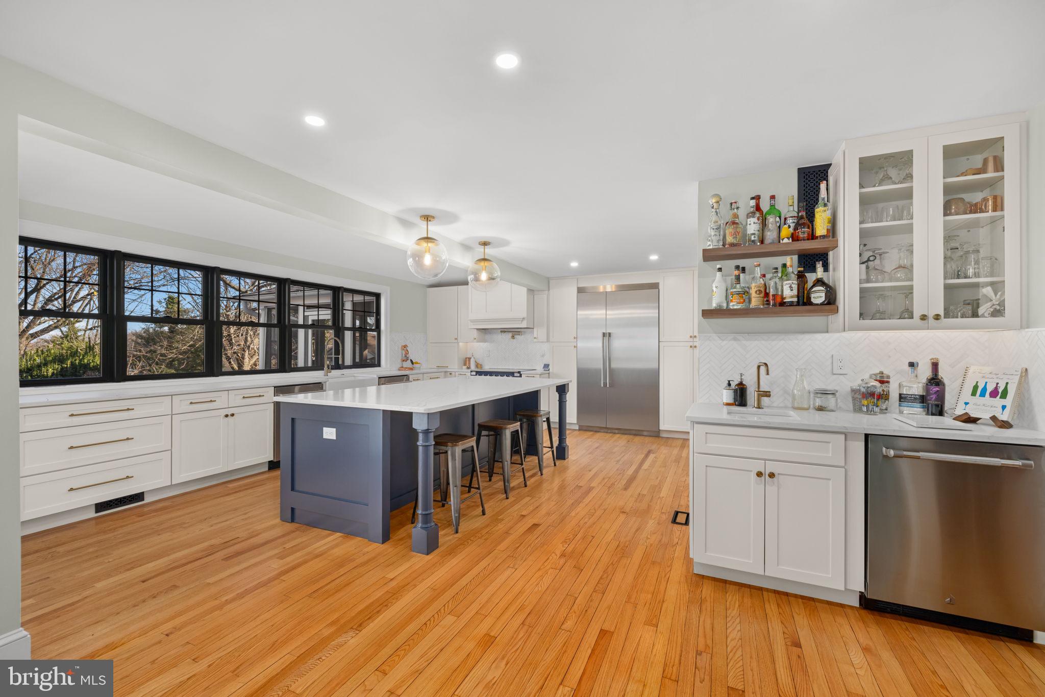 1138 Mayo Road Edgewater, MD 21037 - Photo 8 of 51 a kitchen with stainless steel appliances kitchen island wooden floors and center island