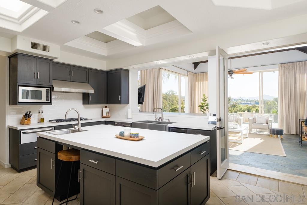 7060 Rancho Cielo Rancho Santa Fe, CA 92067 - Photo 11 of 25 a kitchen with a sink stove and cabinets