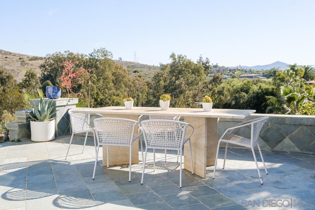 7060 Rancho Cielo Rancho Santa Fe, CA 92067 - Photo 13 of 25 a view of a patio with a table and chairs