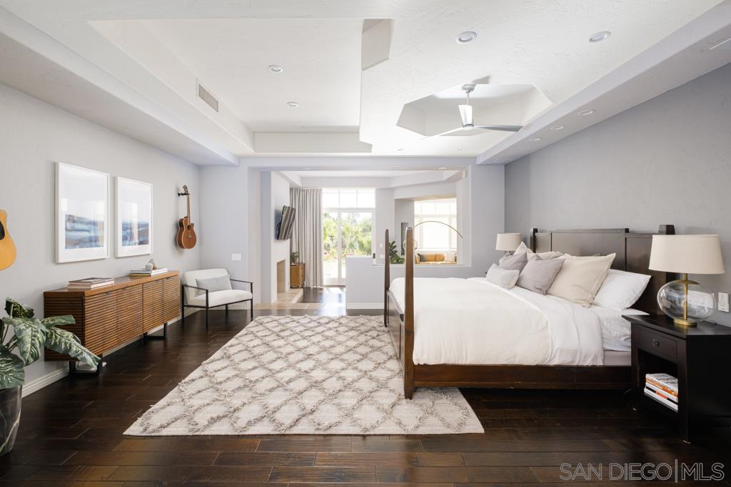 7060 Rancho Cielo Rancho Santa Fe, CA 92067 - Photo 6 of 25 a large bedroom with a bed and wooden floor