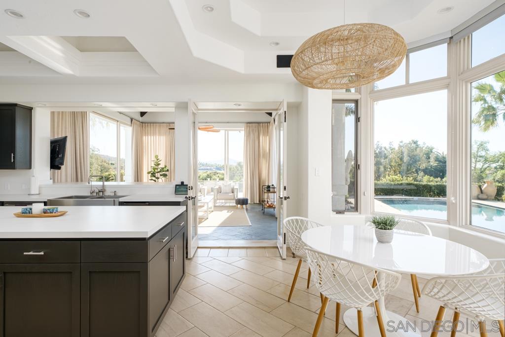 7060 Rancho Cielo Rancho Santa Fe, CA 92067 - Photo 10 of 25 a lobby with a table chairs and chandelier