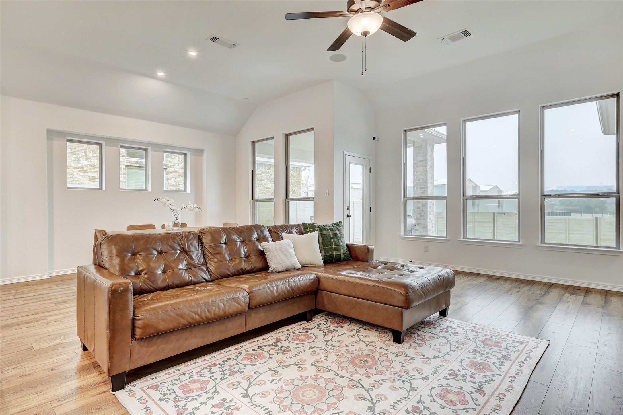 1117 Spring Gulch Lane Georgetown, TX 78628 - Photo 14 of 39 Vaulted ceilings and warm wood flooring define this inviting gathering space.