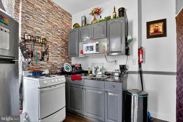 a kitchen with a sink cabinets and appliances