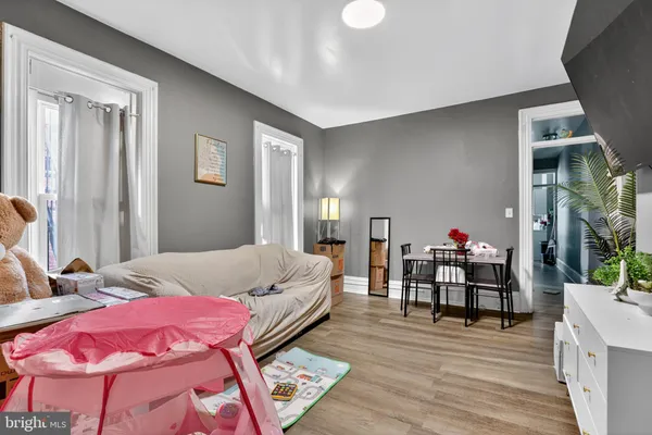 a bedroom with bed and wooden floor