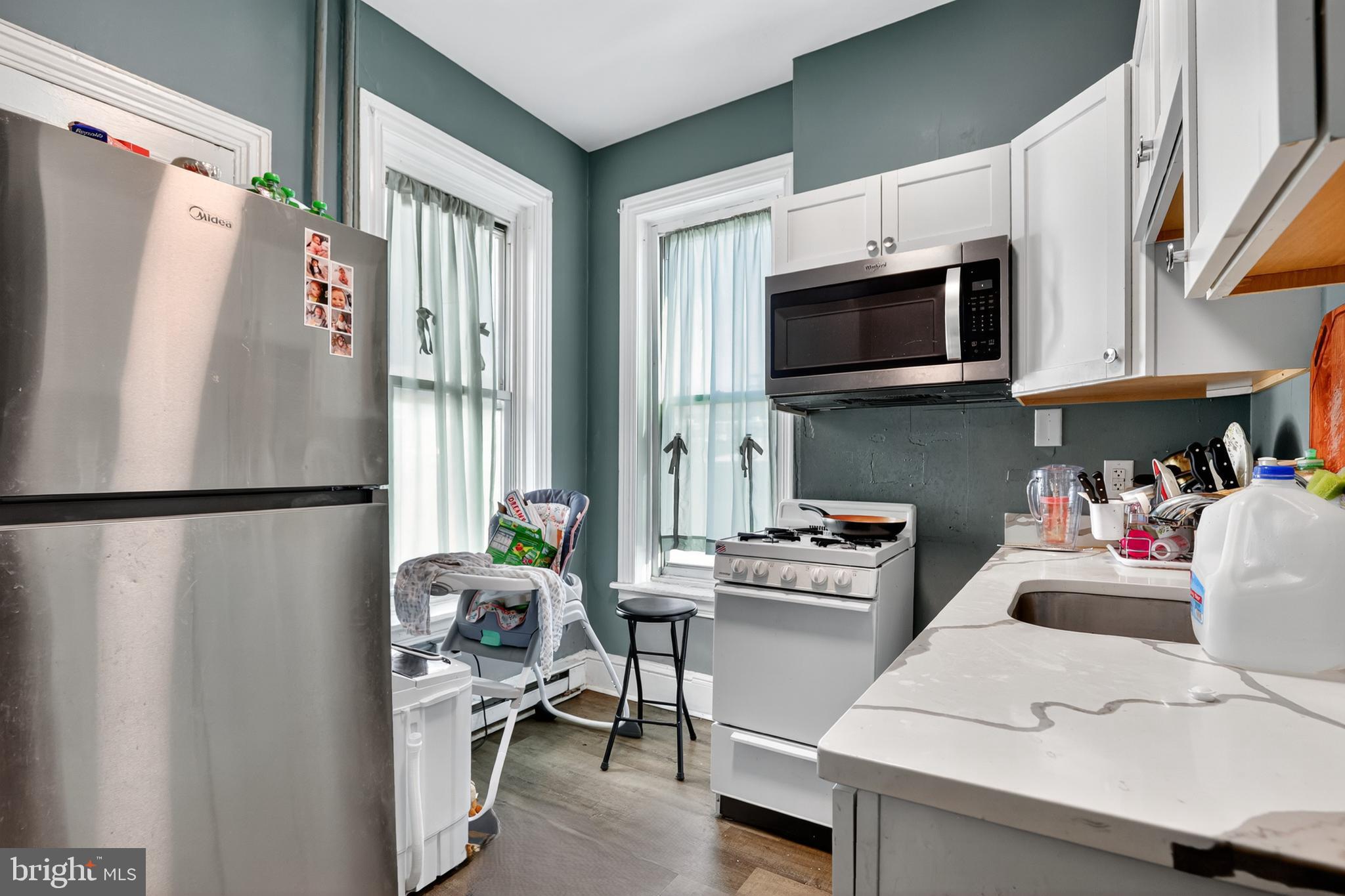 17-19 South 3rd Street Reading, PA 19602 - Photo 22 of 45 a kitchen with stainless steel appliances a refrigerator stove microwave and cabinets