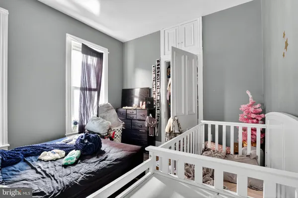 a bedroom with furniture and a window