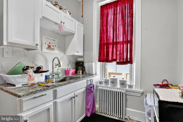 a kitchen with a sink cabinets and window