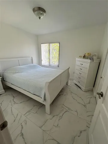 a bed sitting in a room next to a window