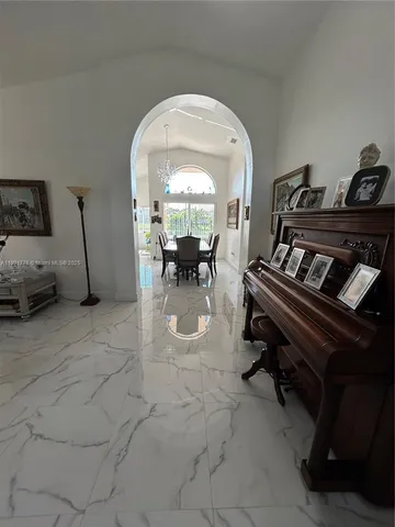 a living room with furniture a couch and a flat screen tv