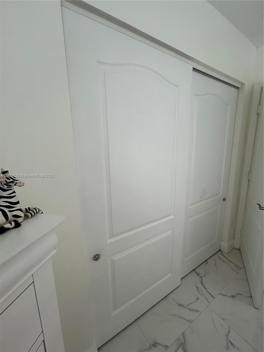 16620 Southwest 101st Terrace, Unit 1 Miami, FL 33196 - Photo 3 of 13 a bathroom with a shower and vanity