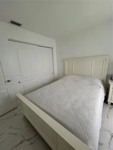a bedroom with a bed and cabinet