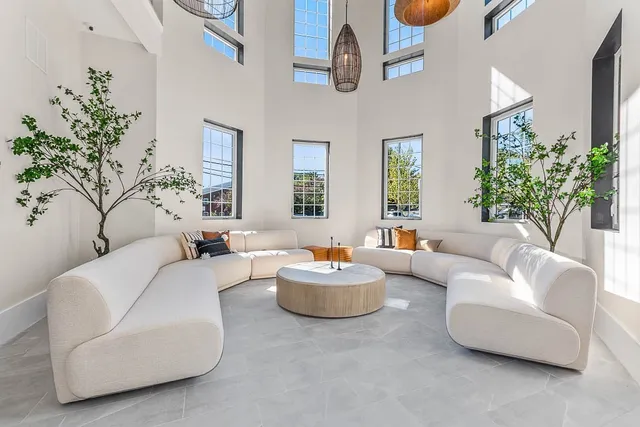 a living room with furniture and a chandelier