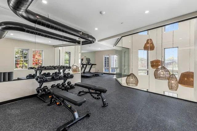 a room with gym equipment and a table