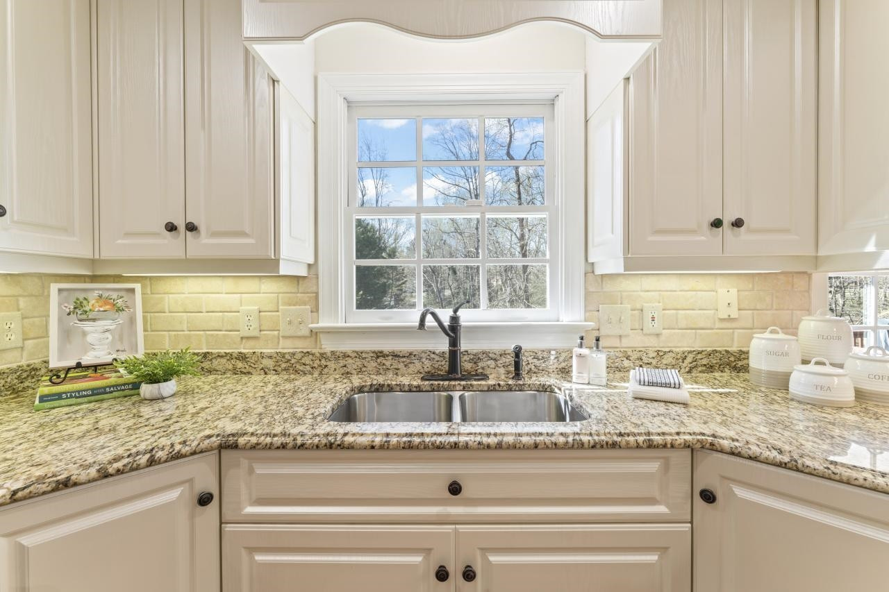5013 Trail Ridge Drive Raleigh, NC 27613 - Photo 10 of 32 Granite countertops and a beautiful view of your large backyard make this a kitchen you'll want to be in. Kitchen