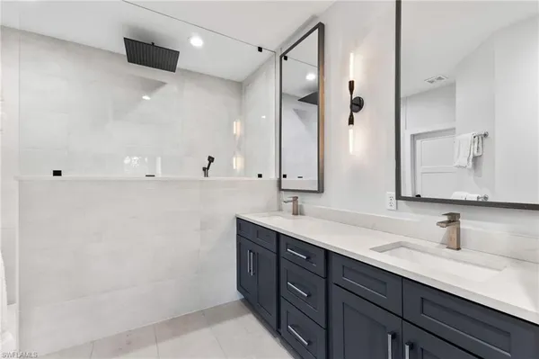 a bathroom with a double vanity sink mirror and double