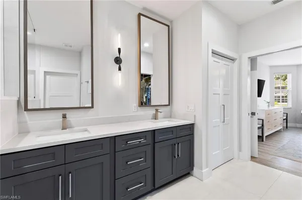 a bathroom with a double vanity sink and mirror