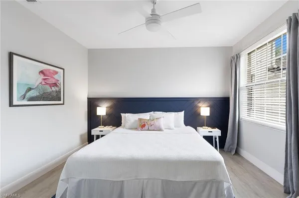 a bedroom with a large bed and a window