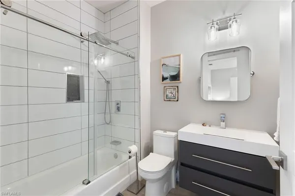 a bathroom with a sink toilet and shower